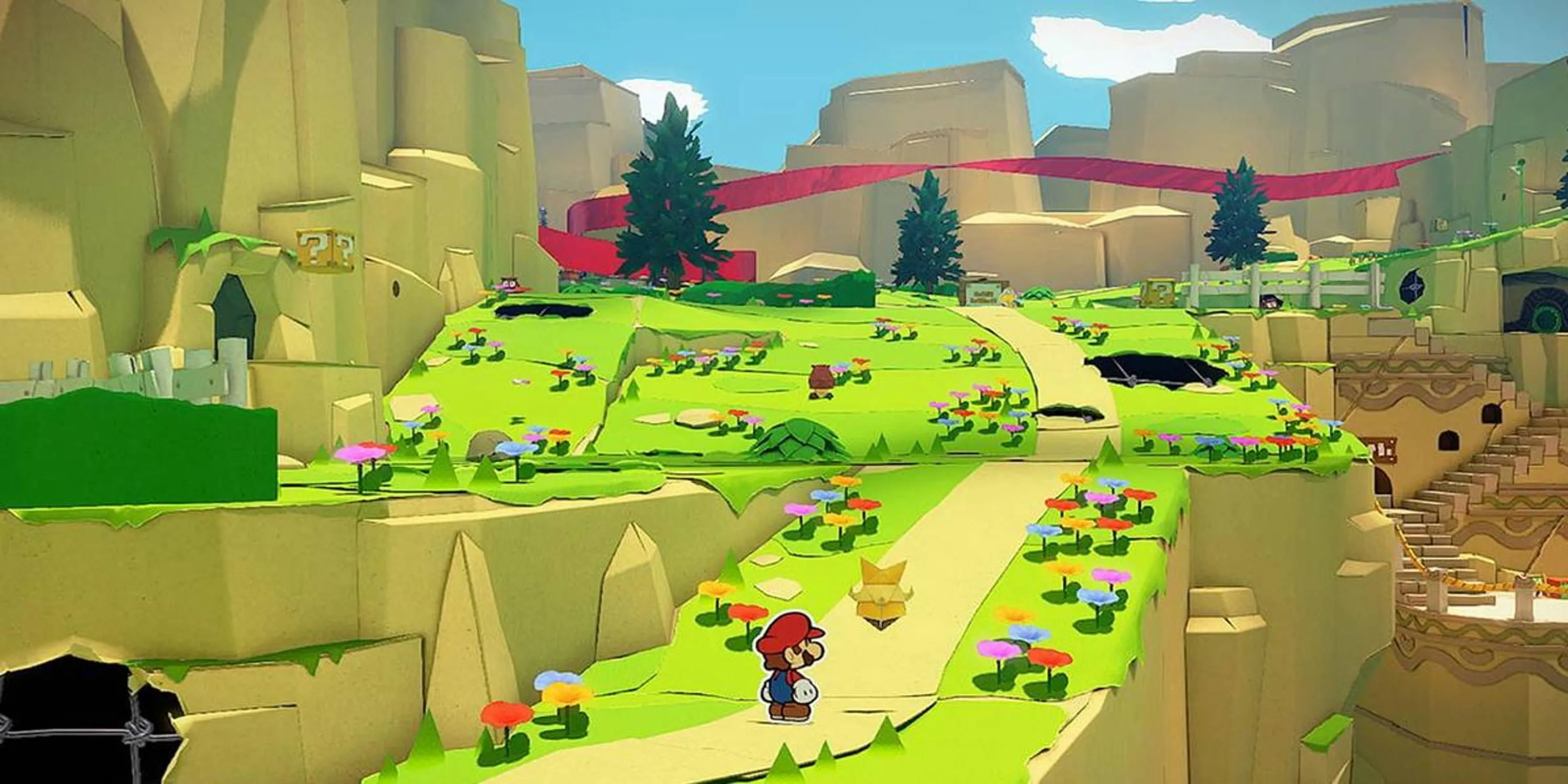 Mario đứng trên con đường dẫn lên đồi trong Paper Mario The Origami King, thể hiện phong cách nghệ thuật độc đáo của game