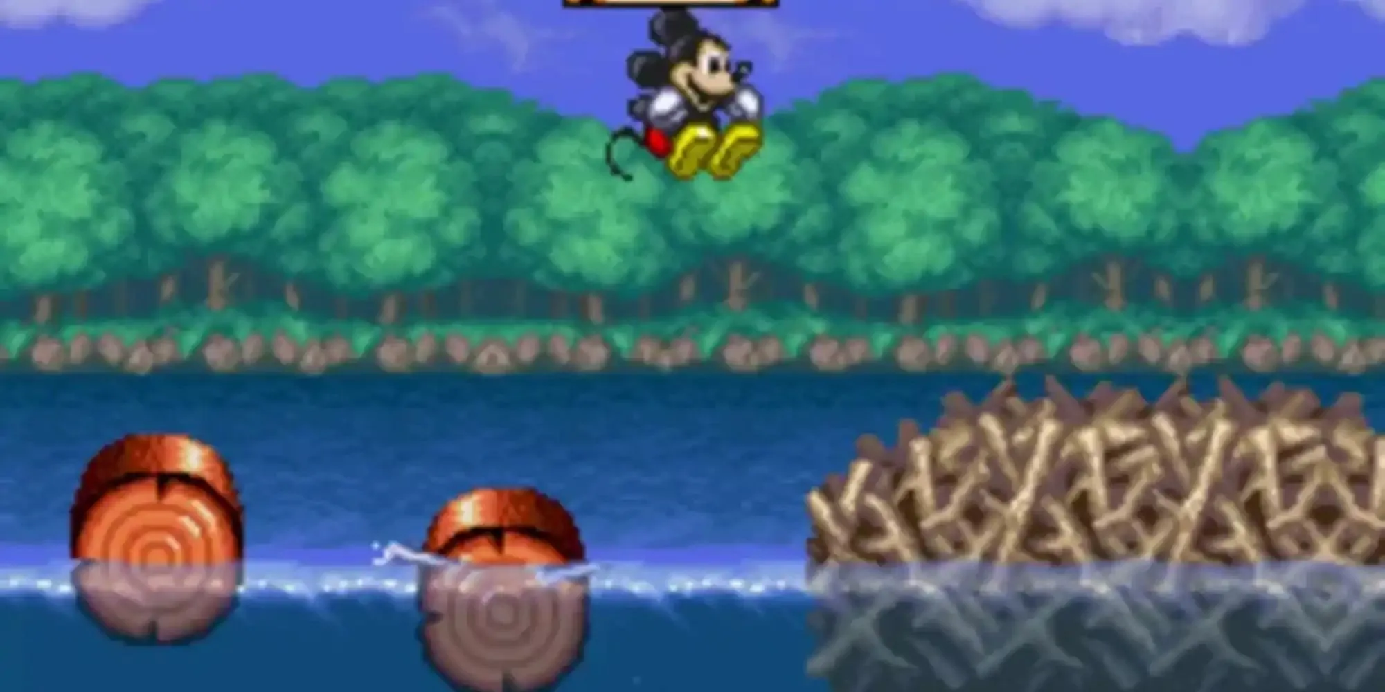 Mickey Chuột mặc trang phục ảo thuật gia, sử dụng phép thuật trong game The Magical Quest Starring Mickey Mouse, thể hiện đồ họa pixel art rực rỡ và lối chơi platformer cổ điển.