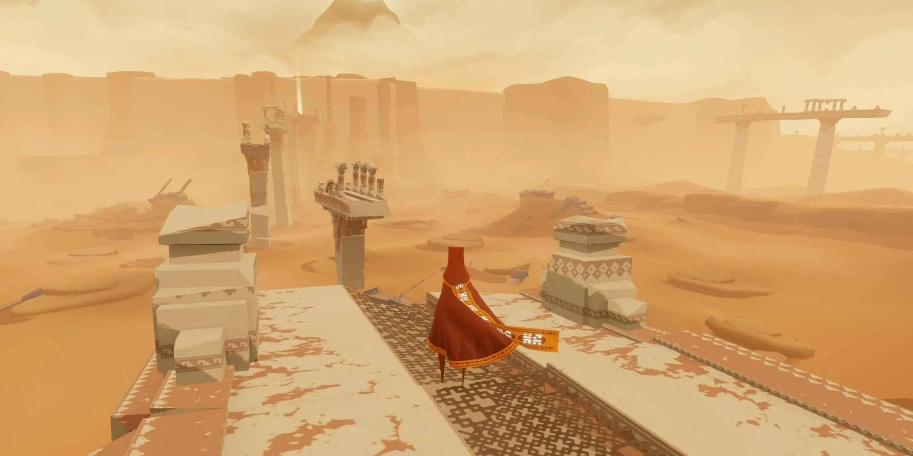 Một người khoác áo choàng đỏ đứng nhìn ra sa mạc rộng lớn với những tàn tích trong game Journey, khắc họa không khí huyền bí, phiêu lưu và nghệ thuật.